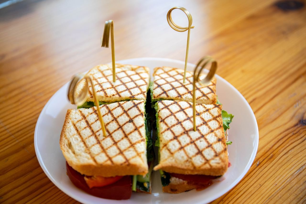 Home Delicious grilled sandwich on a white ceramic plate, ready to serve.